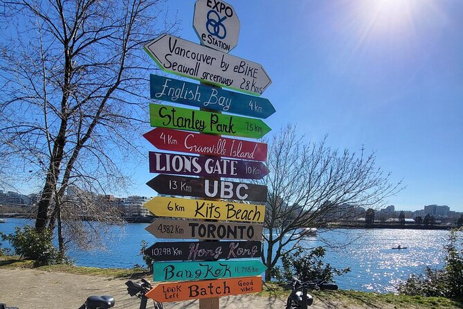 Vancouver E-Bike Rentals - Premium Seawall Bike Path Location - Stanley Park icons: totem poles and the A-Maze-ing Laughter stop